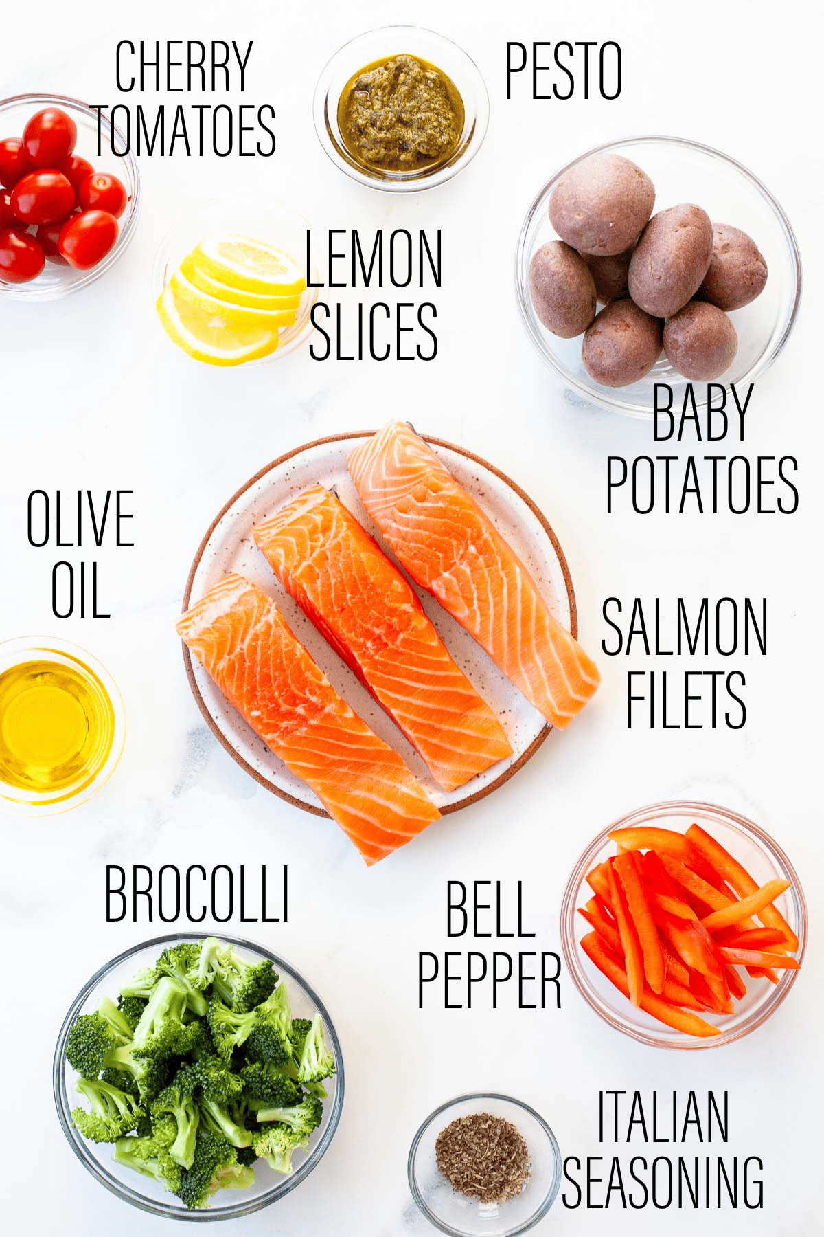 ingredients for sheet pan salmon and roasted veggies on a white table